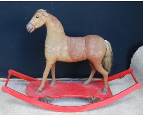 Vintage rocking horse, the whole covered in material, 90cm high.