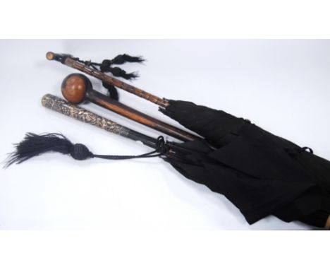 Two vintage parasols, one with a tortoiseshell handle, the other with a white metal handle, also a hardwood stick.   (3)