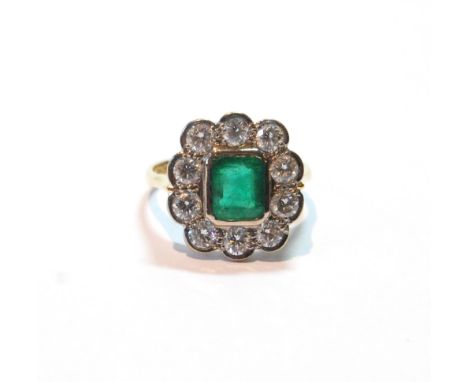 Diamond and emerald cluster ring, the rectangular emerald surrounded by ten diamond brilliants, each approximately .15ct, in 