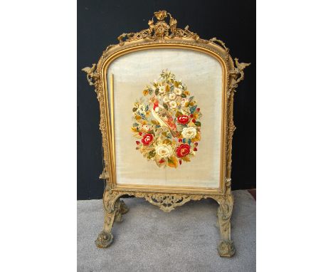 Victorian gilt framed firescreen with stumpwork panel of a bird in flowers, 110cm high.