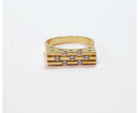 Gold ring with seven diamonds upon three strips, '750', 7g.