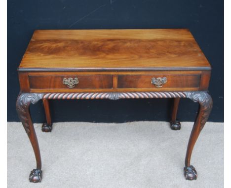 Chippendale style mahogany hall table, the moulded rectangular top over two short drawers and gadrooned frieze, raised on aca