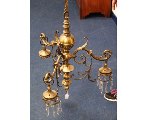 Gilt metal three-branch chandelier with baluster column mounted by a ball finial, the scrolling floral branches terminating i