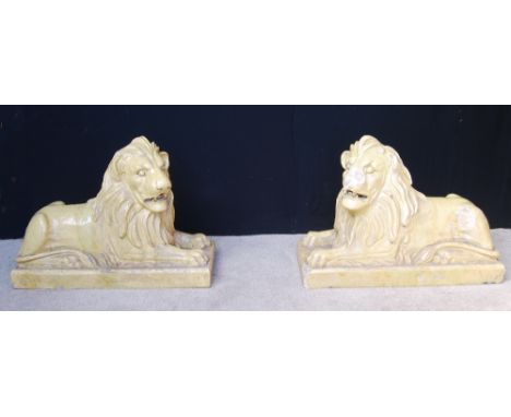 Two lion garden ornaments by R(A) Brown & Son, Ferguslie, Paisley, in fireclay, 106cm long, 42cm wide and 80cm high. Conditio