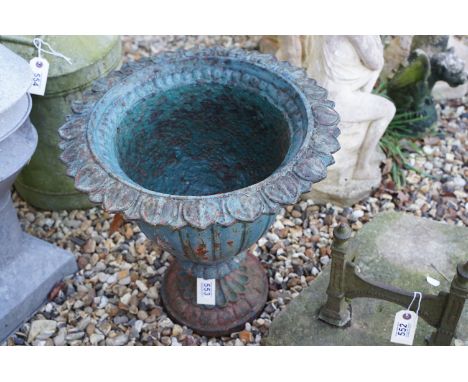 Painted cast iron garden planter with leaf detail, raised on a circular foot, approx 45cm high 