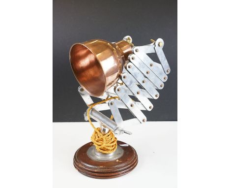 Retro style concertina adjustable table lamp, with coppered shade, raised on a circular wooden base 