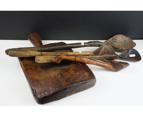 Antique carved wooden chopping block with handle together with four carved wooden ladle spoons with splayed bowls. Largest sp