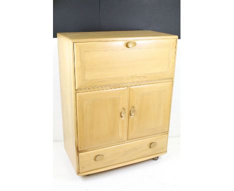 Ercol Pale Elm Windsor Cocktail or Serving Cabinet, model no. 469, with drop front over two cupboard doors and drawer below, 