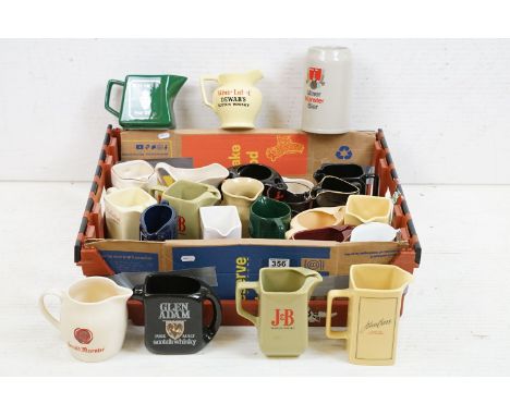 Advertising - A collection of 24 ceramic water jugs, mainly Scotch whisky examples, featuring Chequers, Carling, Red Hackle, 