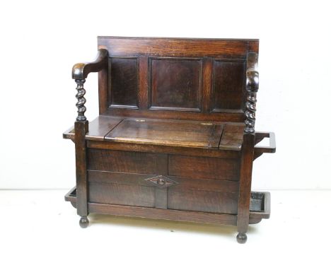 Early to Mid 20th century Oak Hall Seat with panelled back and lift up hinged box seat, the arms with barley-twist supports a