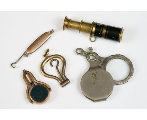 A group of five miniature collectables to include two yellow metal button hooks, bloodstone and carnelian watch winder and a 