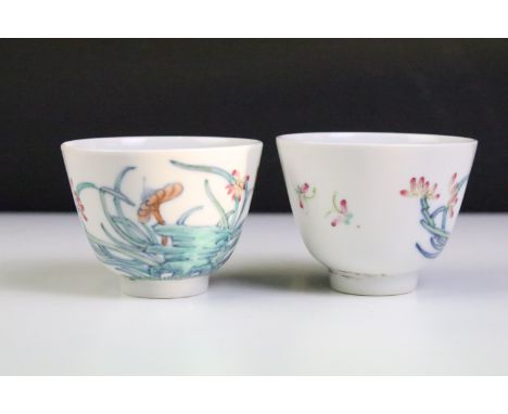 Pair of Chinese porcelain tea bowls with enamel floral &amp; insect decoration, six-character marks to bases, approx 5.5cm ta