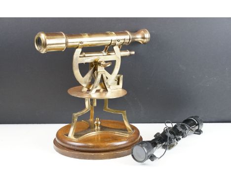 Brass surveyors theodolite, raised on a turned mahogany base, approx 28cm tall; together with a Baizhong 4 x 32 rifle scope 