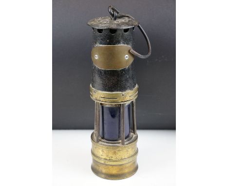 Late 19th Century / early 20th Century miners lamp having a swing handle to the top and blue glass shade. Measures 36cm tall 