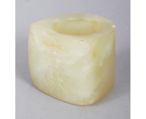 A CHINESE JADE LIKE ARCHER'S RING, decorated in relief to one side with two characters, 1.25in wide at widest point & 1.1in h
