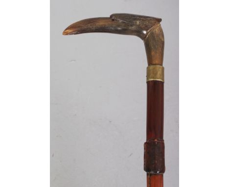 A HORN HANDLED BAMBOO WALKING STICK, with a metal collar, the handle carved in the form of a bird's head, the horn possibly r