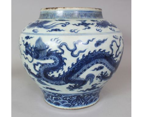 A LARGE CHINESE MING STYLE BLUE & WHITE PORCELAIN DRAGON JAR, the base unglazed, 14.25in wide at widest point & 13in high.