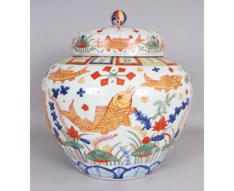 A LARGE CHINESE WUCAI STYLE PORCELAIN JAR & COVER, decorated with fish swimming amidst water weeds, the base with a six-chara