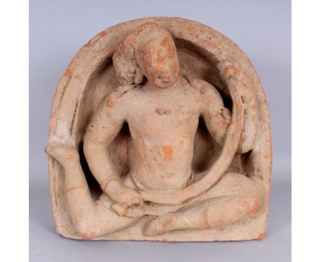 A Gupta Architectural Panel, Central India, 4th/5th century, red terracotta, modelled in relief, depicting a gandharva within