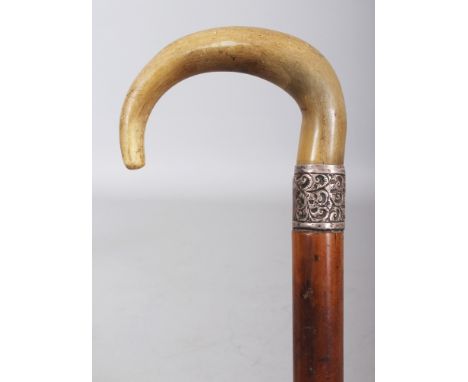 A HORN HANDLED MALACCA WALKING STICK, with an embossed and faintly hallmarked silver collar, the horn possibly rhinoceros hor