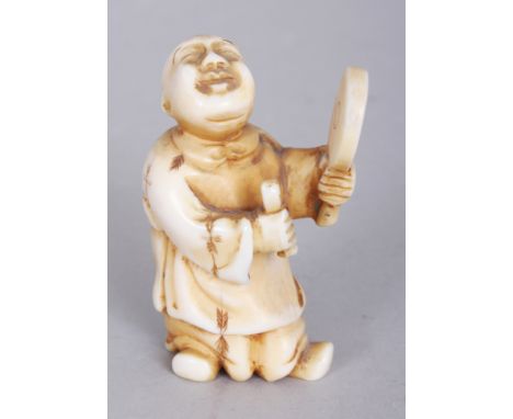 A SIGNED JAPANESE MEIJI PERIOD IVORY NETSUKE OF A STANDING BOY, with uplifted face and holding a mirror, the base with an eng