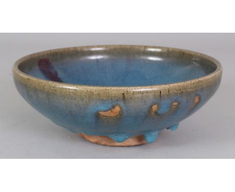A CHINESE JUN WARE PURPLE SPLASH CERAMIC BOWL, the base unglazed, 7in diameter & 2.7in high.