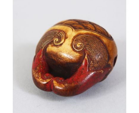 A JAPANESE EARLY MEIJI PERIOD CARVED STAG ANTLER NETSUKE OF A MOKUGYO, carved and stained, himotoshi formed through the openi