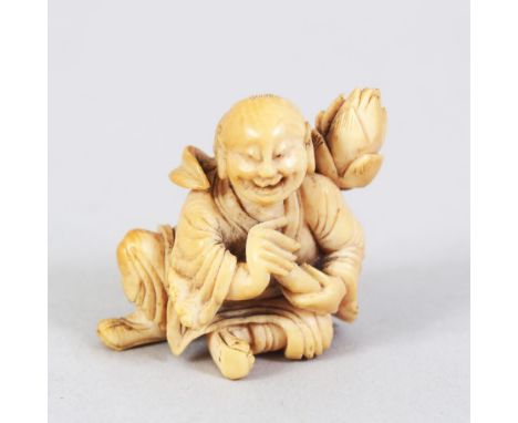A JAPANESE LATE EDO / MEIJI PERIOD CARVED IVORY NETSUKE OF A LAUGHING MAN, the man in a seated position with a lotus flower u