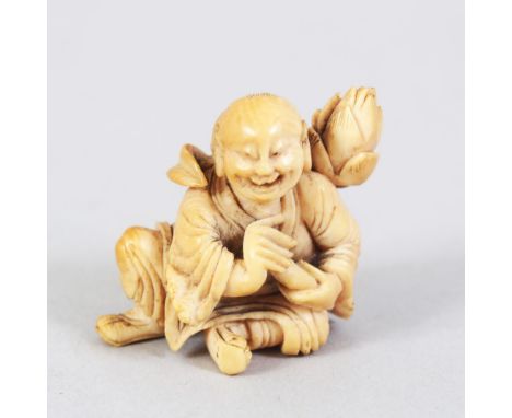 A JAPANESE LATE EDO / MEIJI PERIOD CARVED IVORY NETSUKE OF A LAUGHING MAN, the man in a seated position with a lotus flower u