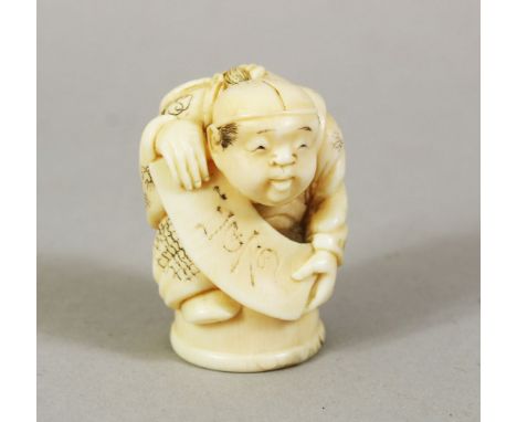 A JAPANESE MEIJI PERIOD CARVED IVORY NETSUKE OF A BOY, the boy stood holding a scroll, 3.8cm high.