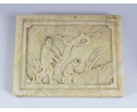 A 20TH CENTURY CHINESE CARVED JADE / SOAPSTONE PLAQUE, depicting two figures in an exterior setting, the upper right section 