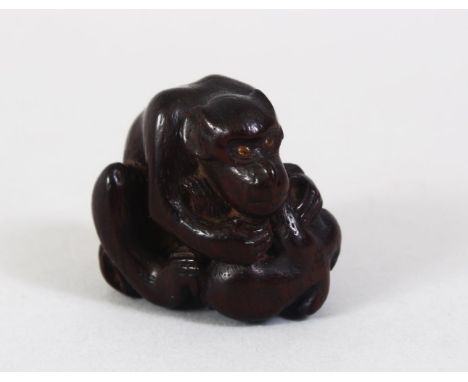 A JAPANESE MEIJI PERIOD CARVED WOODEN NETSUKE OF A MONKEY &amp; YOUNG, the adult seated over its young, the young monkey hold