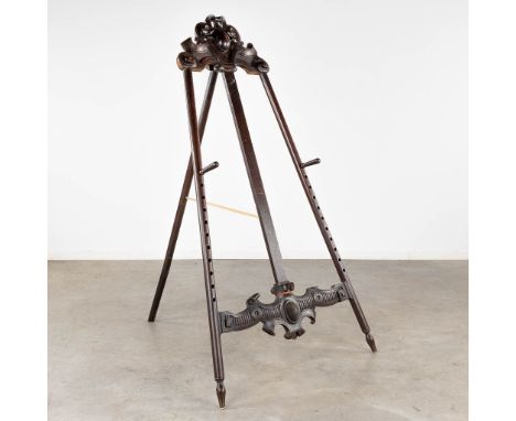 An antique painter's easel, sculptured wood.&nbsp;Dimensions:(W:100 x H:177 cm)