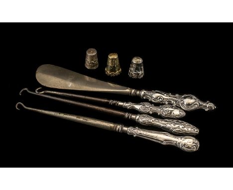 A Collection of Three Silver Handled Button Hooks, together with a silver handled shoe horn and three thimbles.