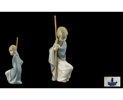 Lladro Nativity Figure of a Shepherd Boy, kneeling down with a crook in hand. 7 inches in height.
