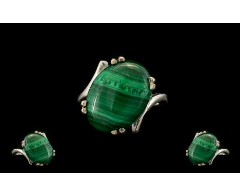 Malachite Solitaire Ring, a 16ct oval cut cabochon of the distinctive green stone, malachite, here set on the diagonal, with 