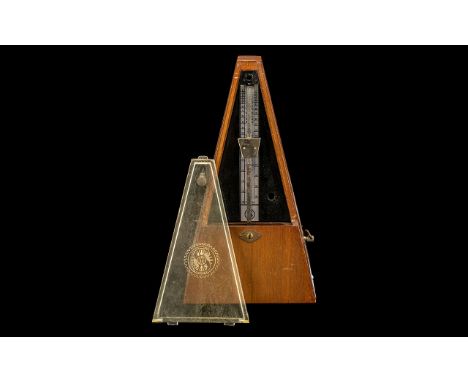 A Mid 20thC Mahogany Cased Metronome. 10 inches in height.