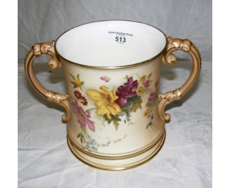 A 15cm high early 20th century Royal Worcester hand-painted floral decorated two handled loving cup