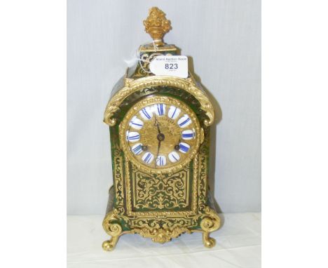 A French green boulle mantel clock with brass dial and enamel numerals, the 8-day movement striking on bell and signed T.A. S