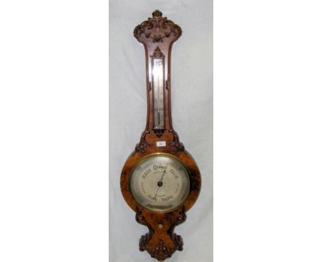 A Victorian walnut wheel barometer/thermometer by Dollond, London
