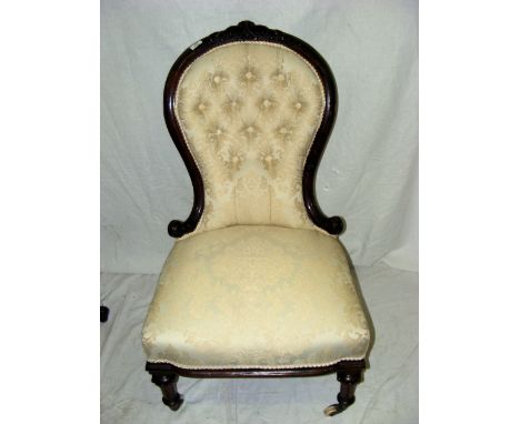 A Victorian walnut nursing chair with deep button back and overstuffed seat