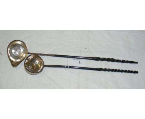 A continental toddy ladle with 1725 coin to the base and a similar George II silver toddy ladle, both with barley twist horn 