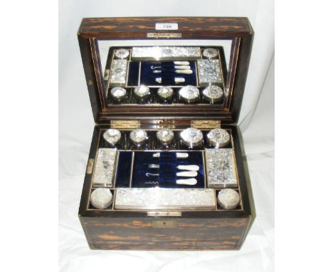 A Victorian brass-bound coromandel wood lady's vanity case with all original chased and engraved silver topped bottles and ja