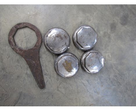 Four chromed wheel hub nuts and a spanner