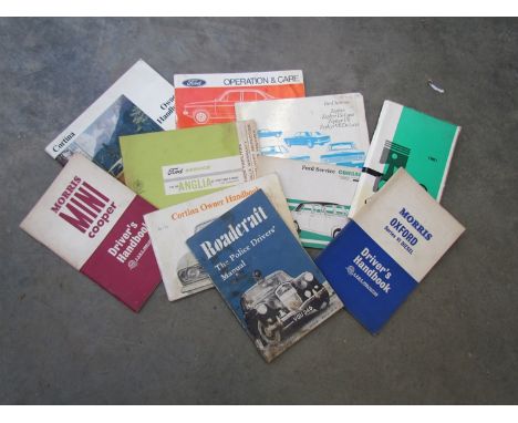  box of manuals including Ford Corsair 2000E, Anglia and Morris Mini Cooper along with a 1960 edition of "Roadcraft, The Poli