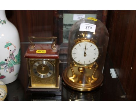 A GLASS DOMED KUNDO MANTLE CLOCK TOGETHER WITH A CARRIAGE CLOCK