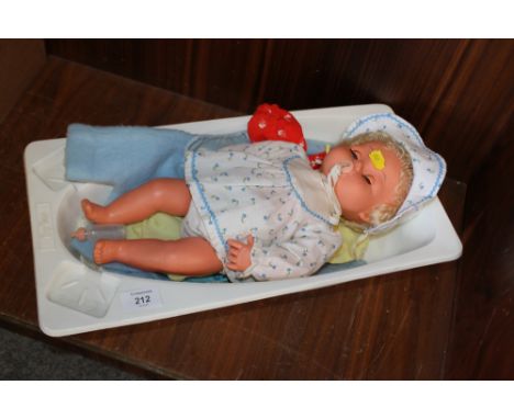 A TINY TEARS ROLLER EYE DOLL WITH SPARE CLOTHES ETC