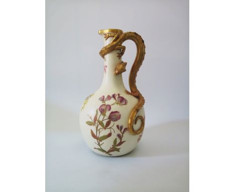 A Royal Worcester Ewer decorated with flowers and handle in the form of a dragon entwined around the ewer, 29 cm