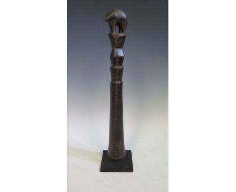 A Central African Carved Hardwood Pestle carved with a four legged animal finial, 46 cm