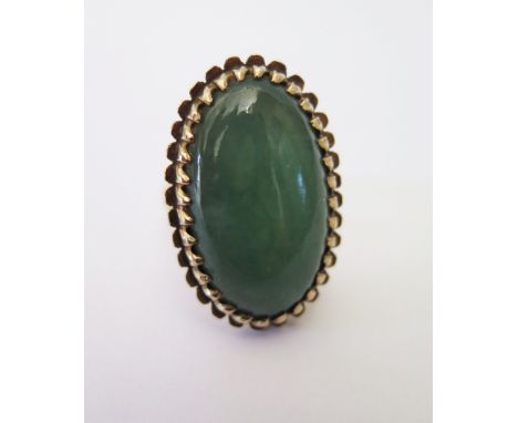 A Cabochon Jadeite Ring in 9ct Gold Mount, c. 27 x 14 mm